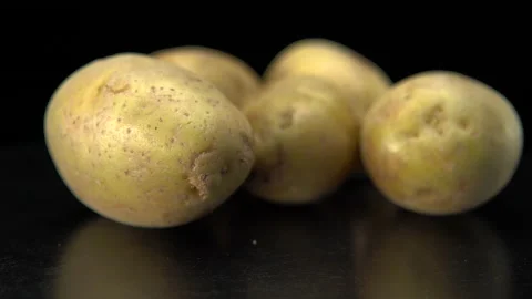 Raw potatoes on a black background close up Stock Footage 147721544