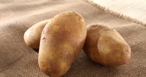 Raw potatoes on burlap. fresh vegetables in rustic style. farm product. Stock Footage 243575554