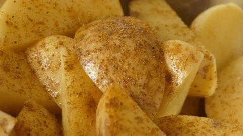 Raw potatoes mixed with spices Stock Footage 142282546
