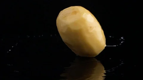 Raw potatoes spinning on black background. Stock Footage 121783180