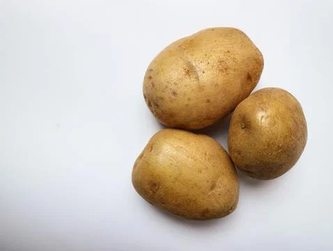 Raw potatoes on a white background Stock Photos