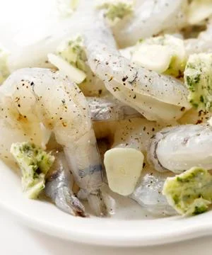 Raw prawns marinated with garlic Stock Photos