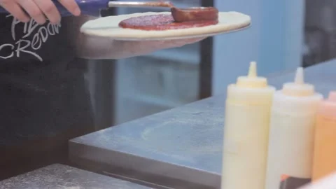 Raw prepared pizza dough is getting saused before baking Stock Footage 143307871