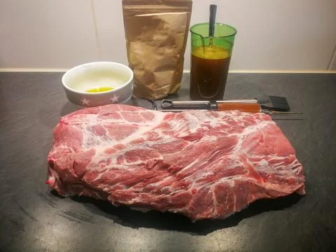 Raw pulled pork marinating in the kitchen Stock Photos