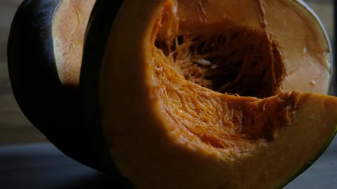Raw pumpkin cut in half with slice, slider shot Video stock 117751748