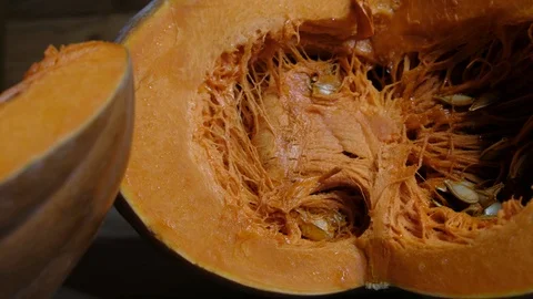 Raw pumpkin cut in half with slice, slider shot Video stock 117752537
