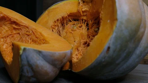 Raw pumpkin cut in half with slice, slider shot Video stock 117752671