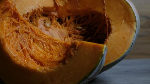 Raw pumpkin cut in half with slice Video stock 117753177