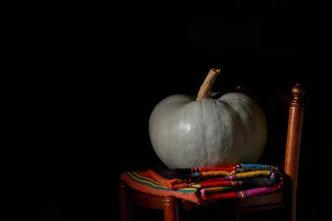 Raw pumpkin on rustic chair Stock Photos
