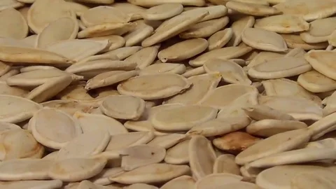 Raw pumpkin seeds rotating, close up overhead view, healthy eco organic food Stock Footage 71981469
