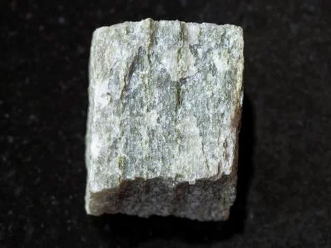 Raw quartz-mica schist stone on dark background Stock Photos