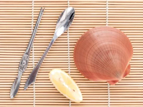 Raw queen scallops with lemon slice ,fork and spoon preparing for grill top v Stock Photos