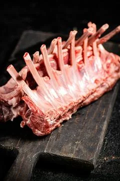 Raw rack of lamb on a cutting board on the table. Stock Photos