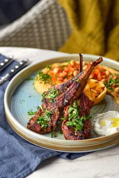 Raw rack of lamb fried with aromatic olive oil, herbs and spices Stock Photos
