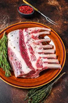 Raw Racks of lamb ready for cooking. Dark background. Top view Stock Photos