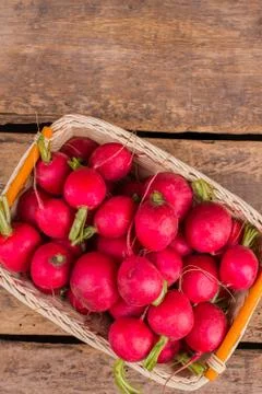 Raw radishes stack in a wicked basket. 스톡 사진