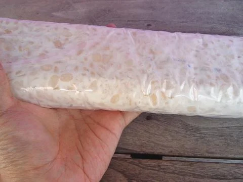 Raw rectangular tempeh that is still in its packaging 스톡 사진
