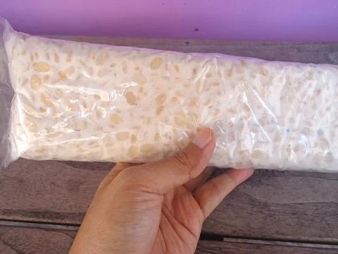 Raw rectangular tempeh that is still in its packaging Фото
