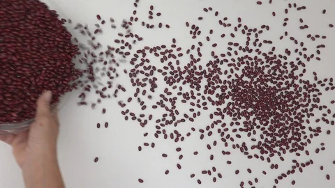 Raw red beans are thrown on the white table with white background. Close up, Stock Footage 128844093