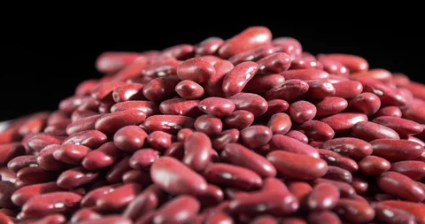 Raw red beans on rotating table with black background Stock Footage 122051468