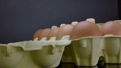 Raw red eggs on a black background Stock Footage 125954884