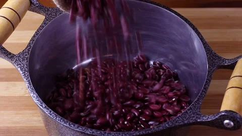 Raw red kidney bean seed grains poured into the pan Stock Footage 252478740