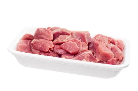 Raw red meat chopped for stew in white tray Foto stock
