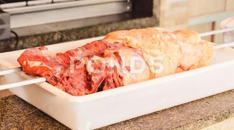 Raw red meat on a white bowl being prepared for a barbecue. No sauce Stock Photos