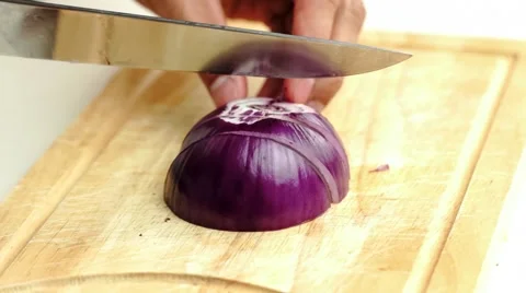 Raw red onion being chopped with knife and picked up by hands, slow motion Stock Footage 68752779