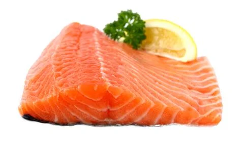 Raw, red salmon fillet with lemon wedge Stock Photos