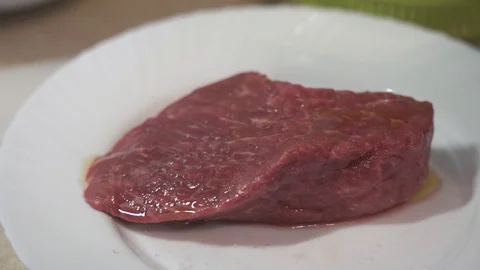 Raw rib eye beefsteak covered with organic olive oil Stock Footage 111512466
