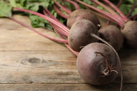 Raw ripe beets on wooden table. Space for text Stock Photos