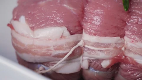 Raw roast beef with bacon and spices close-up, ready to bake in the oven. Stock Footage 329277022