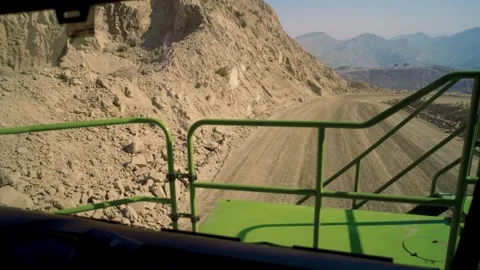 Raw Rock Walls Flank a Mine Truck on the Haul Road Stock Footage 336220878