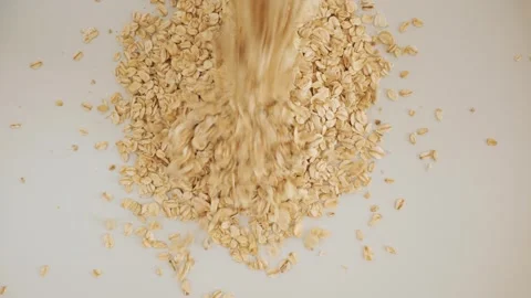 Raw rolled oats falling on an isolated white background Stock Footage 337011711