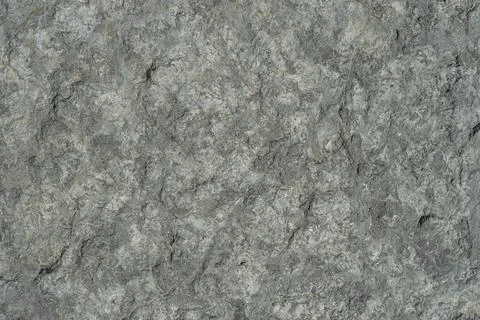 Raw rough dark gray limestone close-up, textured. Stock Photos