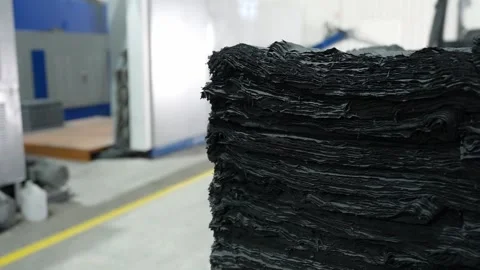 Raw rubber sheets stacked inside an industrial processing facility Stock Footage 324393947