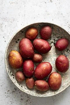 Raw ruby gem potatoes in a bowl Stock Photos