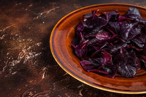 Raw Ruby or red chard salad Leafs on a rustic plate. Dark background. Top view Stock Photos