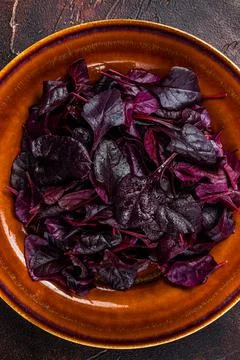 Raw Ruby or red chard salad Leafs on a rustic plate. Dark background. Top view Stockfoto's