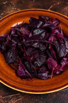 Raw Ruby or red chard salad Leafs on a rustic plate. Dark background. Top view 写真素材