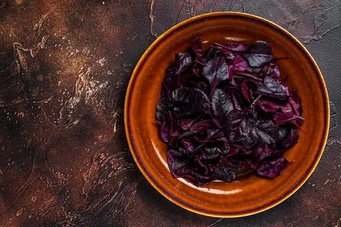 Raw Ruby or red chard salad Leafs on a rustic plate. Dark background. Top view Stock Photos