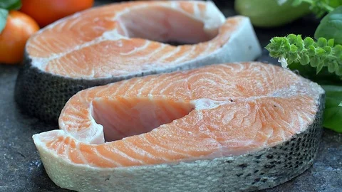 Raw salmon cutlet flavored with spices Stock Footage 121089007