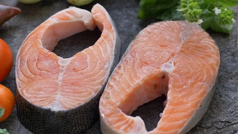 Raw salmon cutlet flavored with spices Stock Footage 121089271