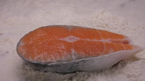 Raw salmon falling into flour 4k Stock Footage 148317242