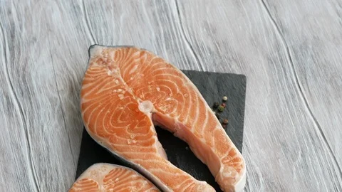 Raw Salmon Steak On A Black Plate Video stock 114026997