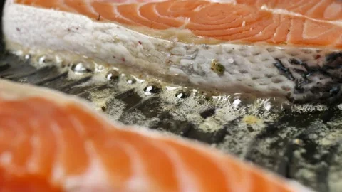 Raw salmon steak fried in a grill pan. chef preparing steak Stock Footage 214761268