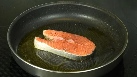 Raw salmon steak in a frying pan. Healthy seafood. Stock Footage 131745489