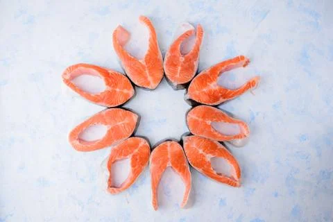 Raw salmon steaks pattern on a blue background top view 스톡 사진