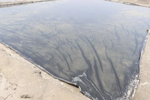 Raw salt farm plot with water and polythene bed 스톡 사진